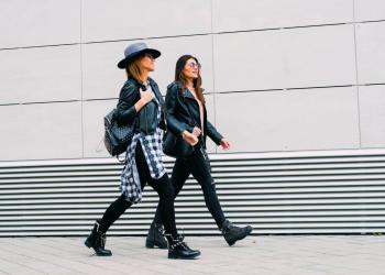 two young women walking in the city street
