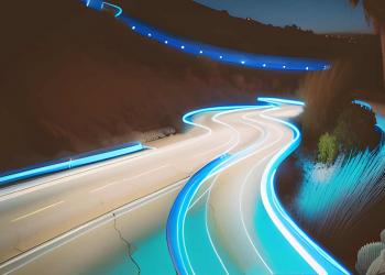 curvy road surrounded by desert at night
