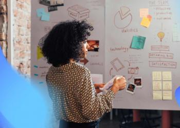 a woman in front of a white board