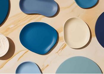 Flatlay of blue hues and cream marble background, soft warm natural light