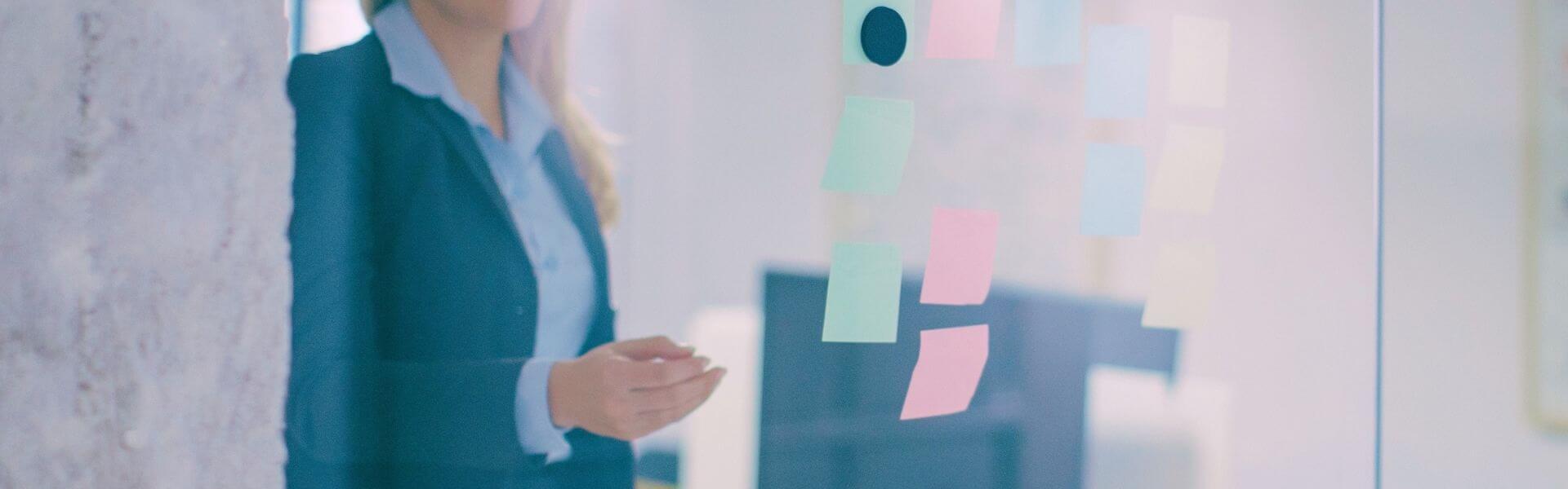 woman placing post-it note