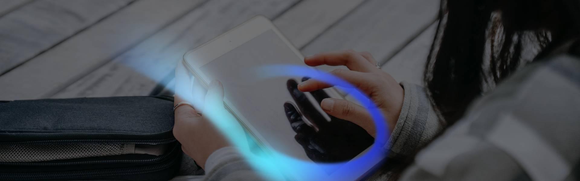 young woman typing on her tablet at edu campus