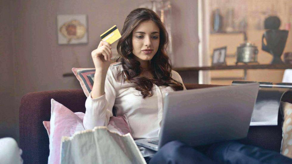 Women holding a credit card to pay online
