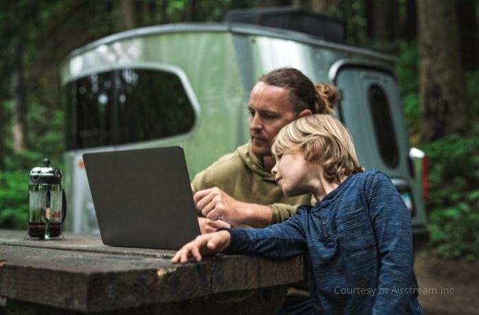 father and son behind Airstream Basecamp Travel Trailer