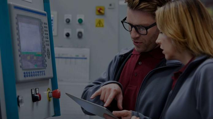 engineer talking to colleague in a warehouse