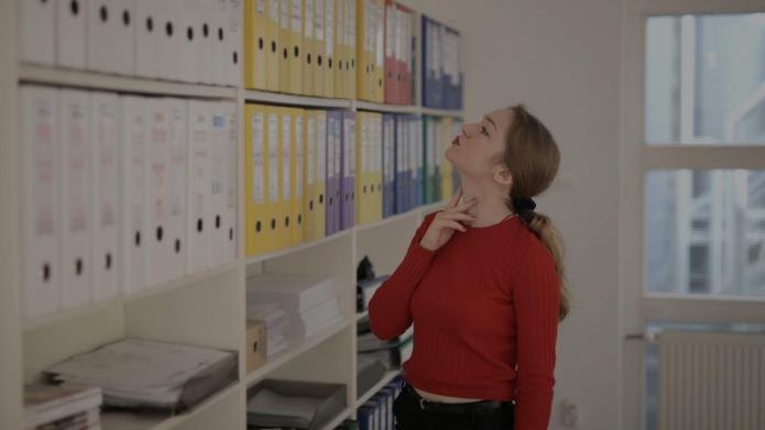 women staring at archived documents